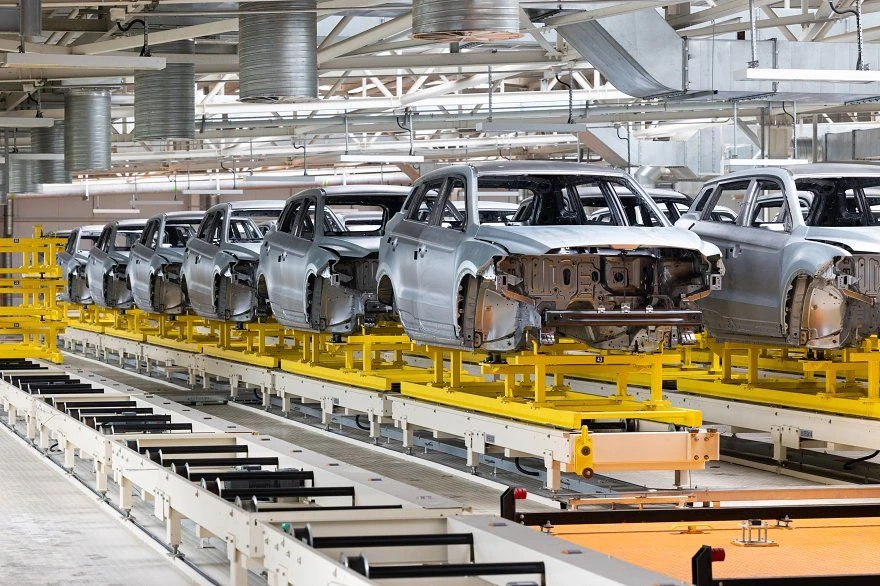 Automotive bodies moving along a manufacturing assembly line